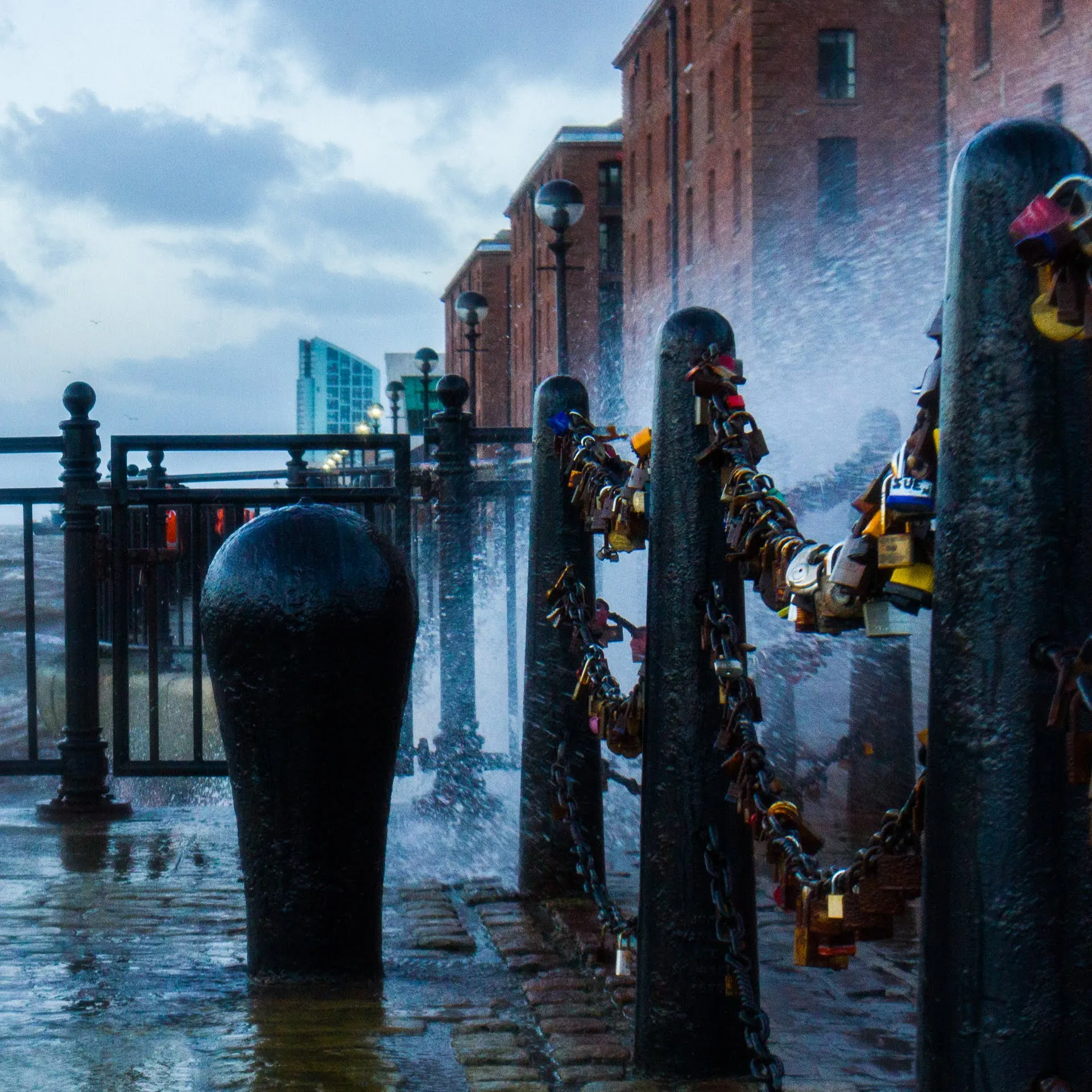Waves crashing against mooring bollards at Albert Dock during a storm
