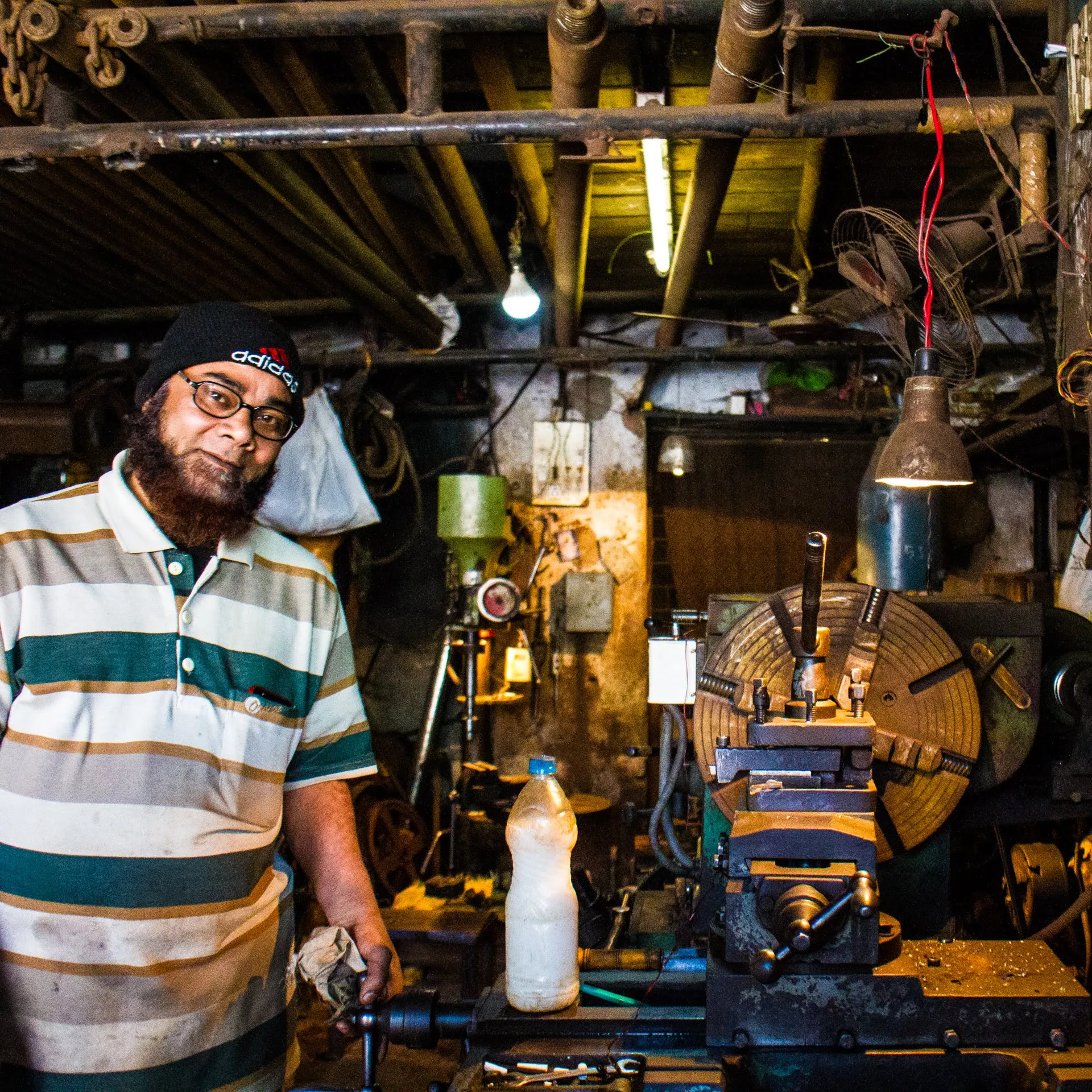 A mechanic pausing for a portrait in his workshop
